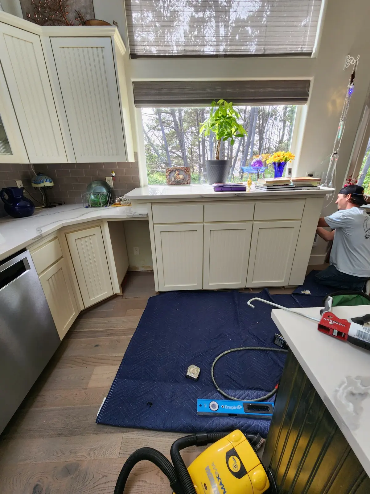 Justin fitting cabinetry during a kitchen installation